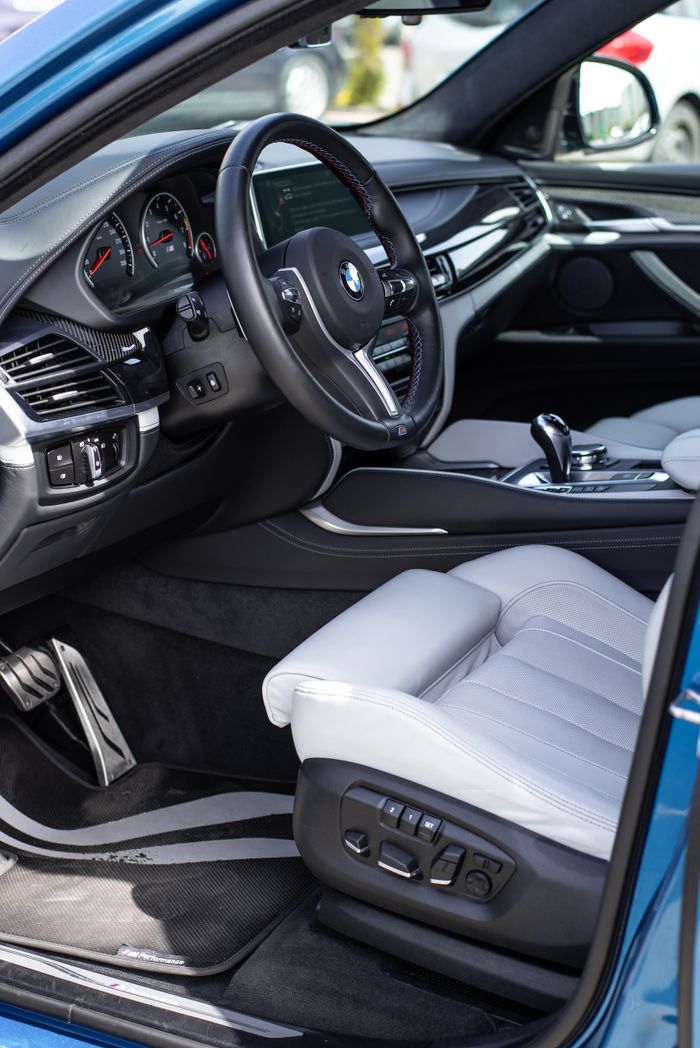 Elegant BMW car interior featuring premium leather seats and a sleek dashboard design.